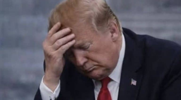 Donald Trump standing in Washington, D.C. during a quiet reflective moment after his presidency