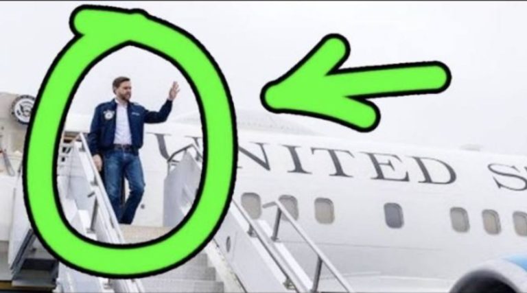 Vance waves while boarding a United States aircraft