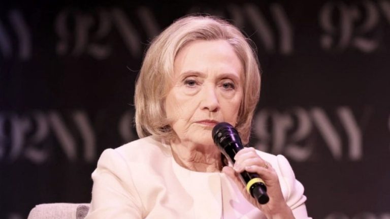 Hillary Clinton speaking into a microphone