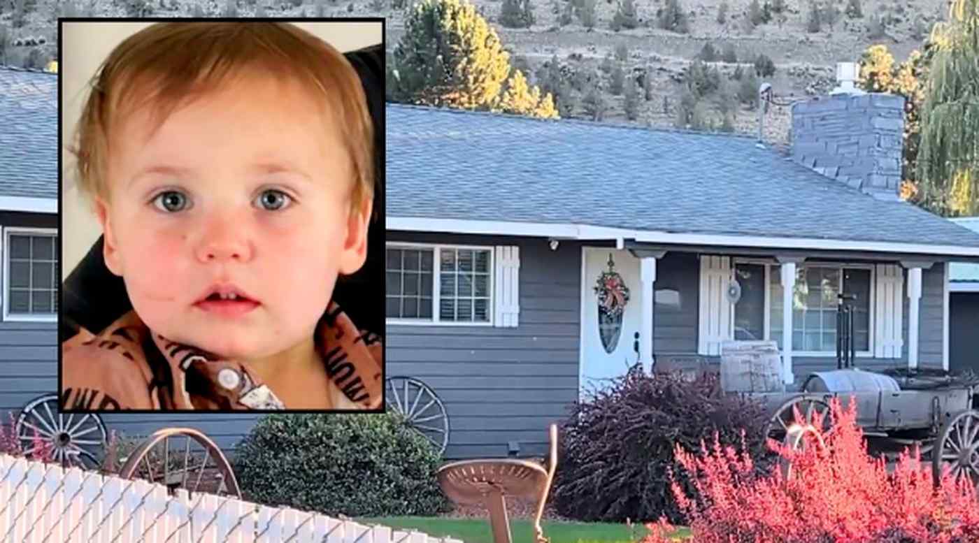 young child with blue eyes in inset photo beside a gray house with stone chimney and