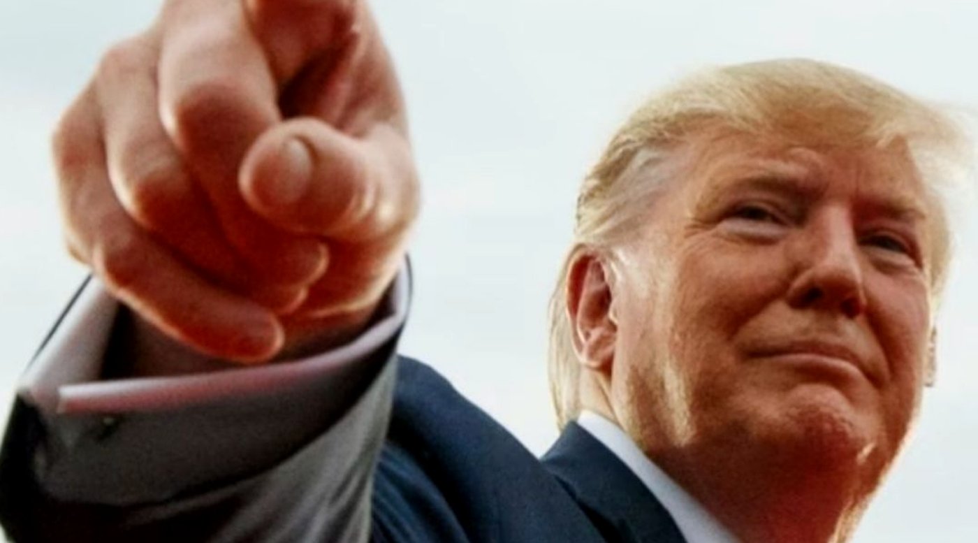donald Trump pointing finger directly at camera during outdoor rally with intense