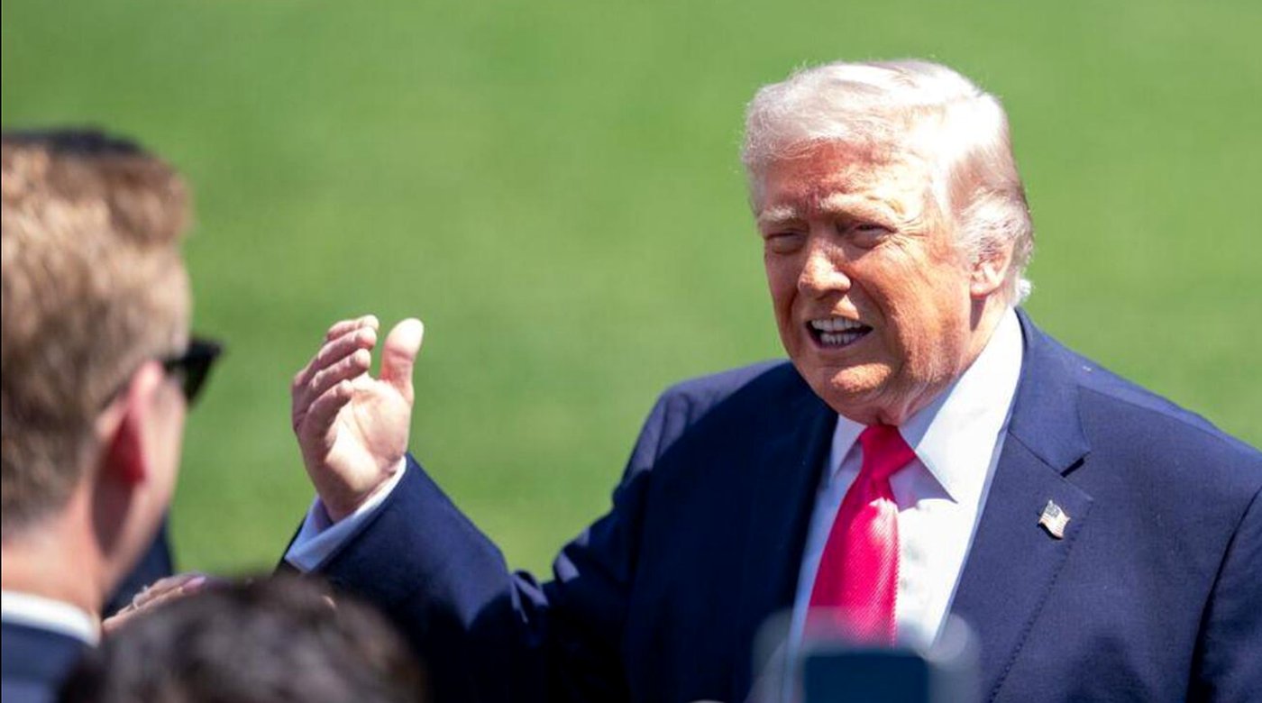 donald Trump gestures while speaking outdoors on a sunny day