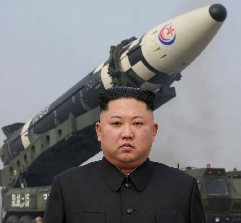 north Korean leader Kim Jong-un stands before a missile launch