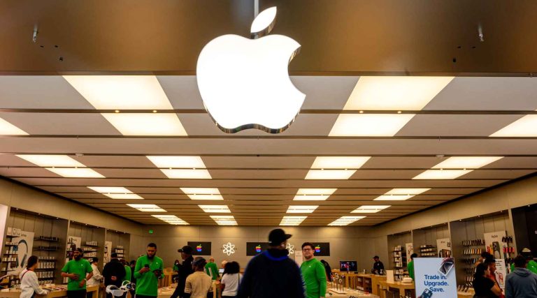 apple Store interior bustling with customers and staff in green shirts
