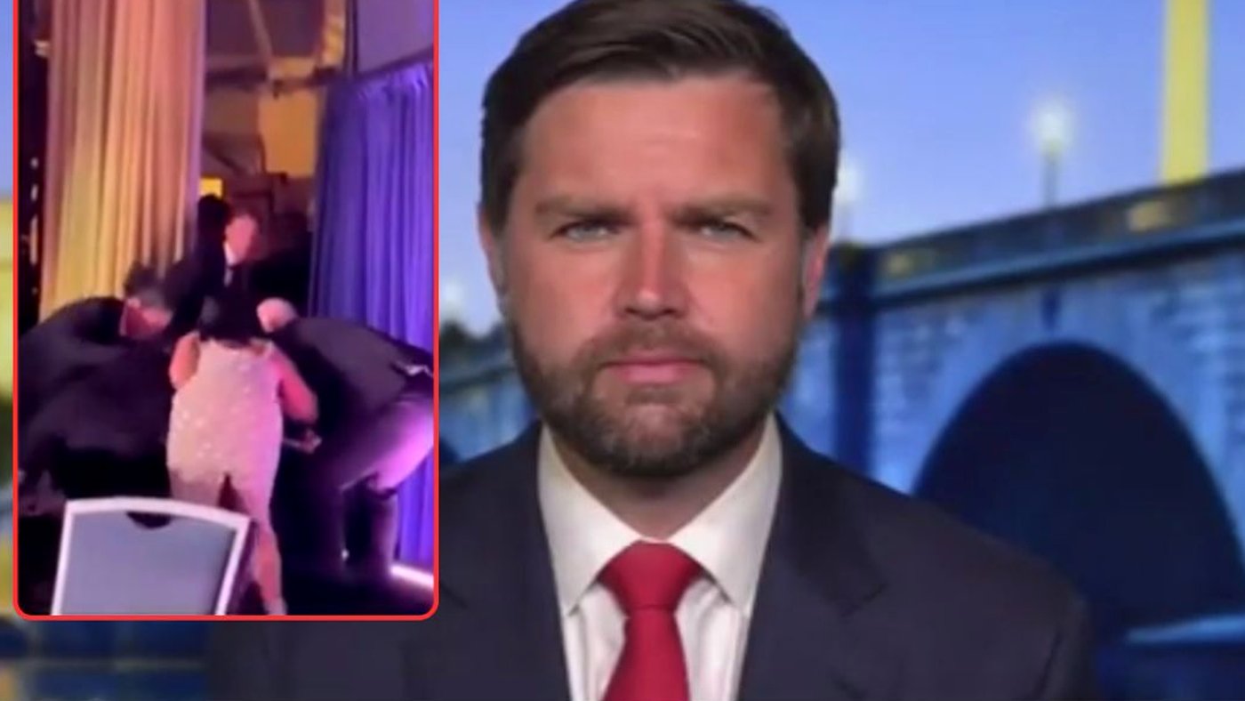 man in suit reacts to chaotic scene behind him at event