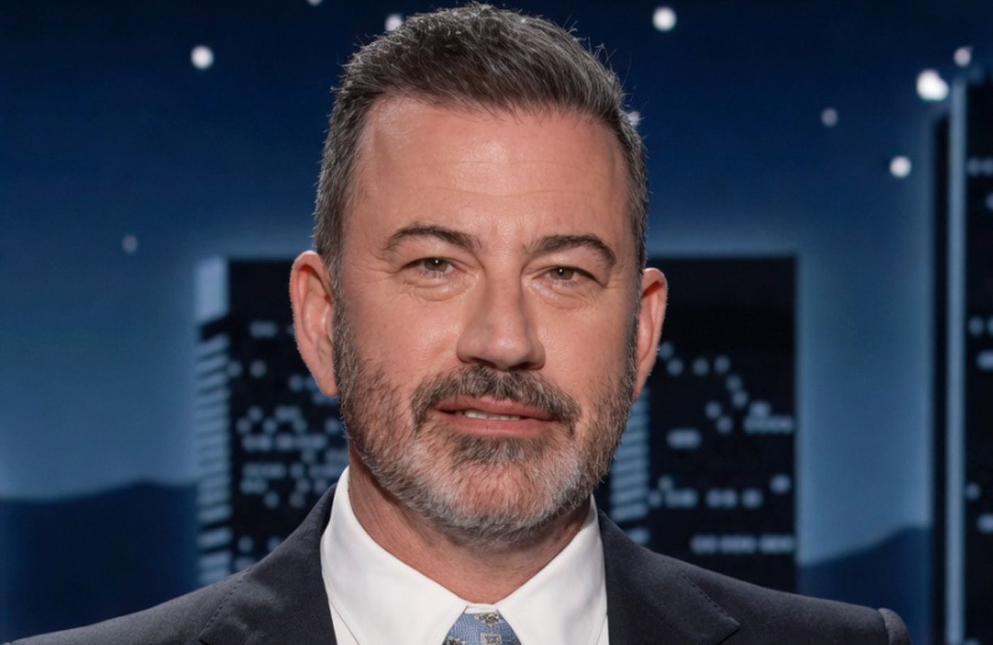 jimmy Kimmel smiling on stage during late-night show taping