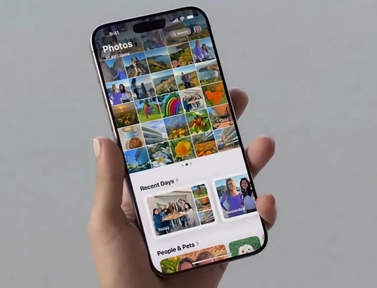 hand holding a smartphone displaying a colorful photo gallery