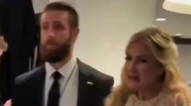 emotional moment between a man and a woman in formal attire