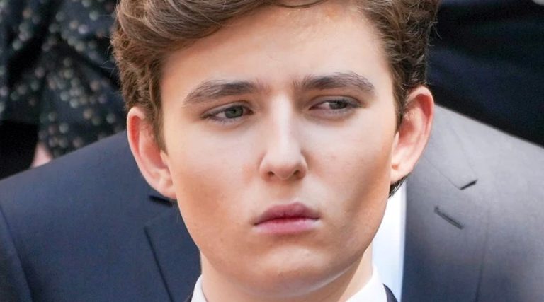 young man in formal attire with a serious expression