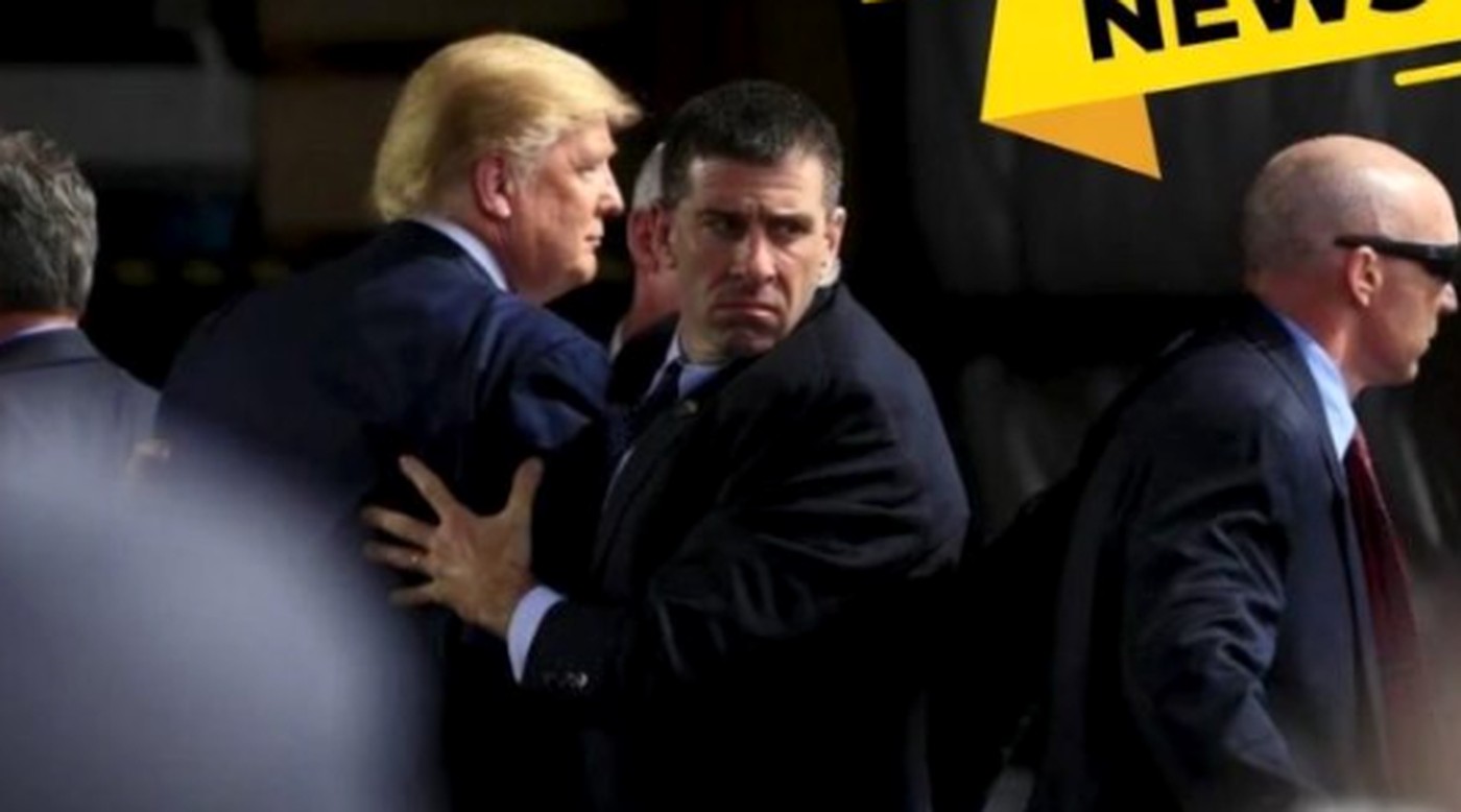 trump escorted by security amidst a chaotic event