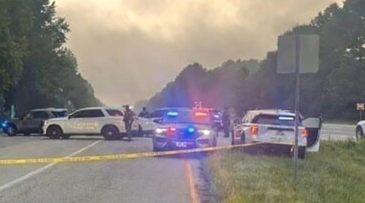 police vehicles at a highway scene with emergency lights flashing