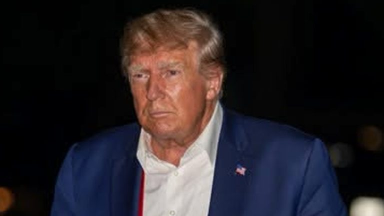 Trump walking at night holding colorful sneakers