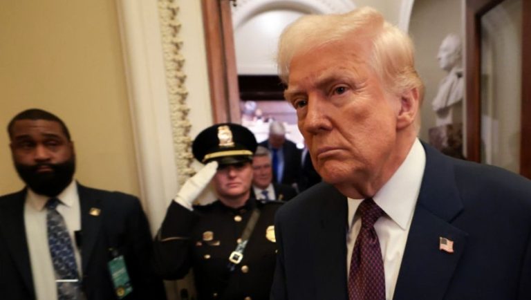 donald Trump walking through a corridor with security personnel