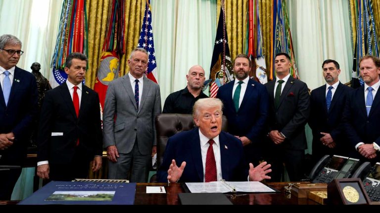 Donald Trump signs an executive order with Joe Rogan.