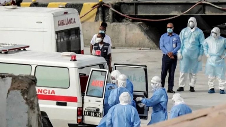 healthcare workers in protective gear assist ambulance team at scene