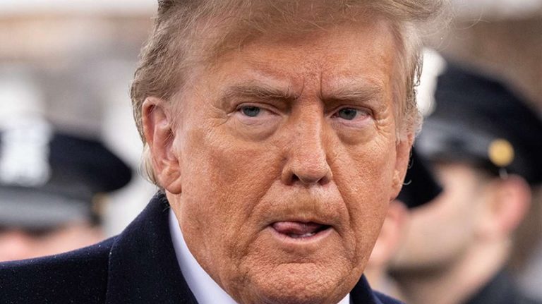donald Trump with intense expression in a crowd setting