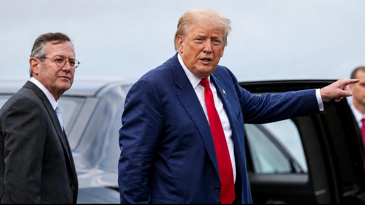 Donald Trump is pointing at a vehicle.