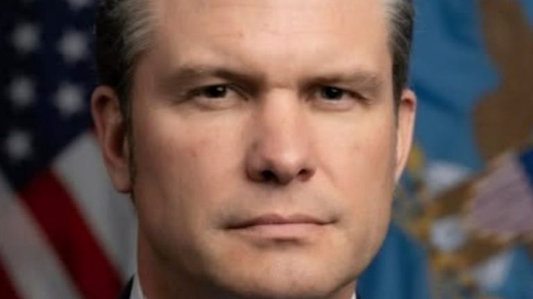 Eric Trump serious close-up portrait with flag
