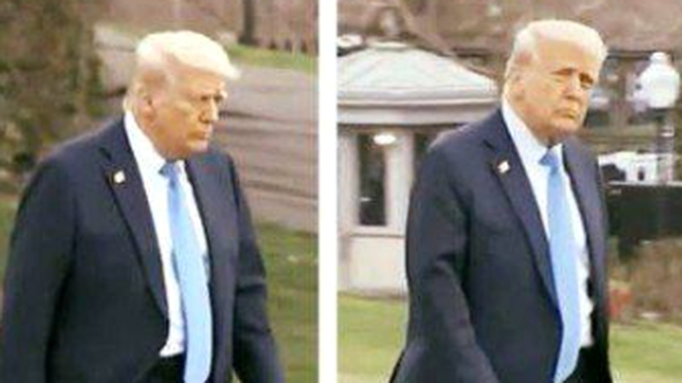 "Donald Trump walking in dark suit and blue tie"