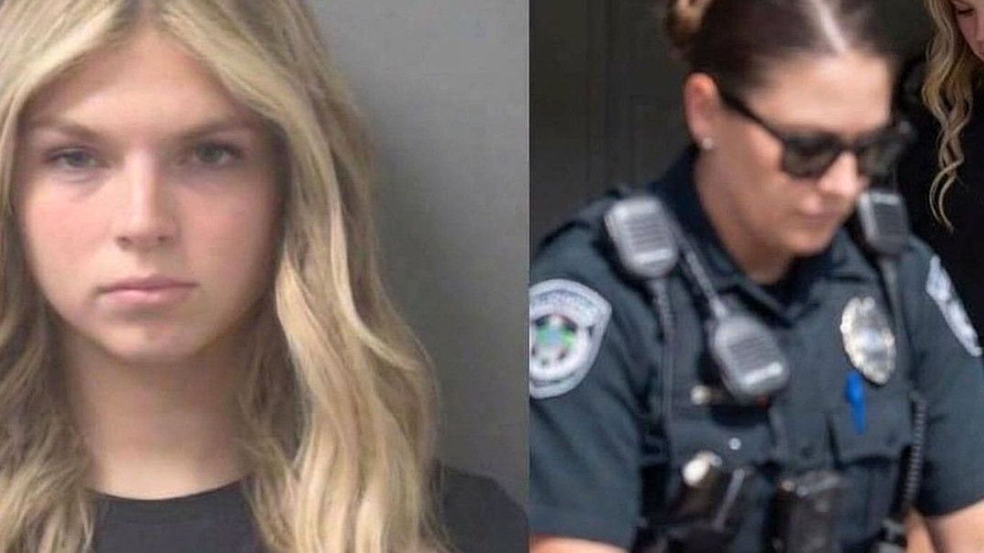"Blonde woman arrested by police in red shorts"