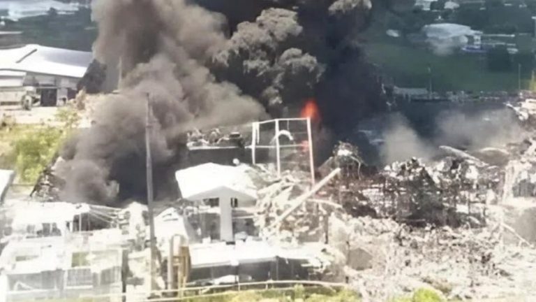 massive smoke cloud billowing from industrial site explosion