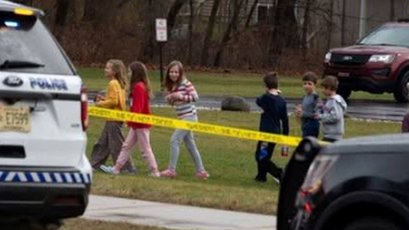 children walking past police tape at a school incident