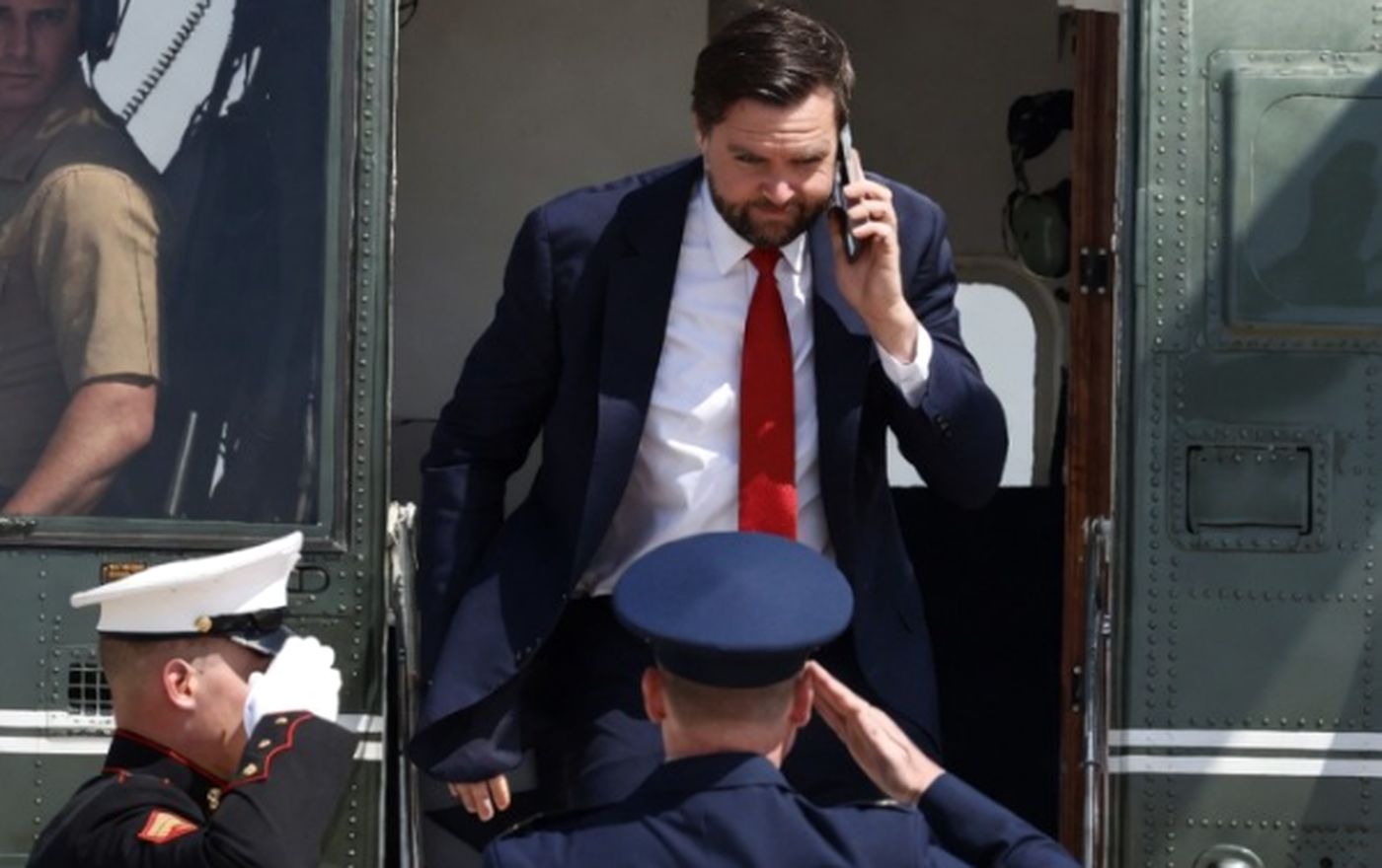 JD Vance exits helicopter saluted by Marines