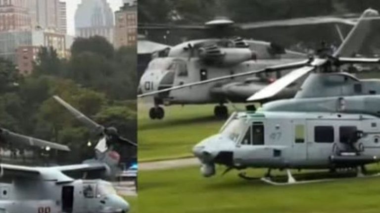 Military helicopters crash landing on grass field