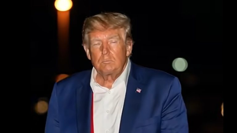 Donald Trump walking at night in blue suit
