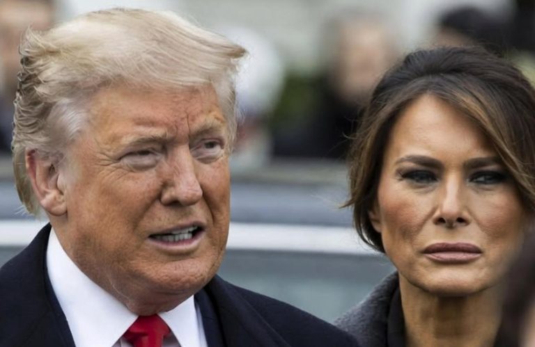 Donald and Melania Trump walking outdoors.