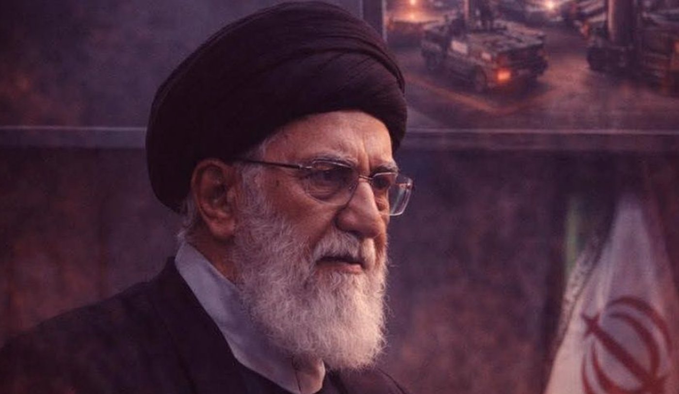 Ali Khamenei speaking in front of a missile graphic.