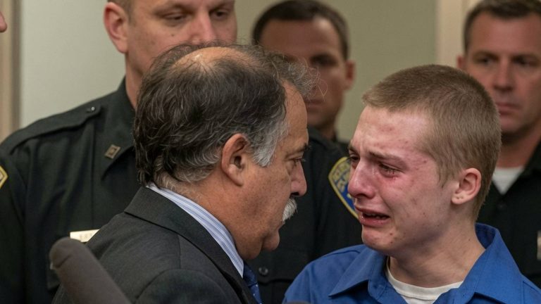 Young man crying while speaking to his attorney.