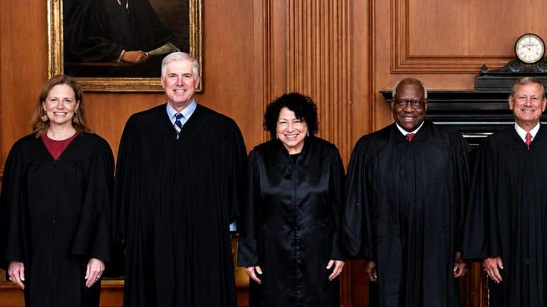 Five Supreme Court Justices standing in a row.