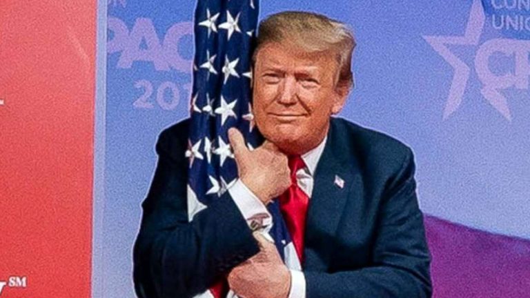 Donald Trump hugging an American flag at CPAC.
