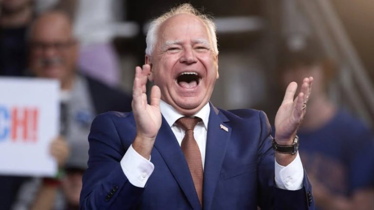 He's busted political figure laughing with hands raised