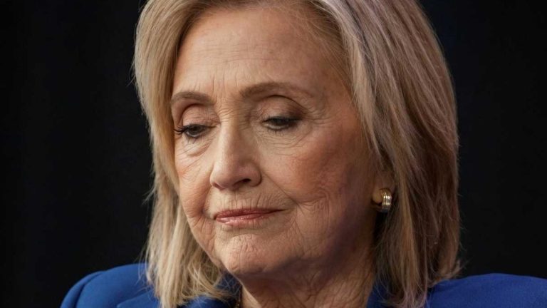 Hillary Clinton speaking with hand gestures in blue suit