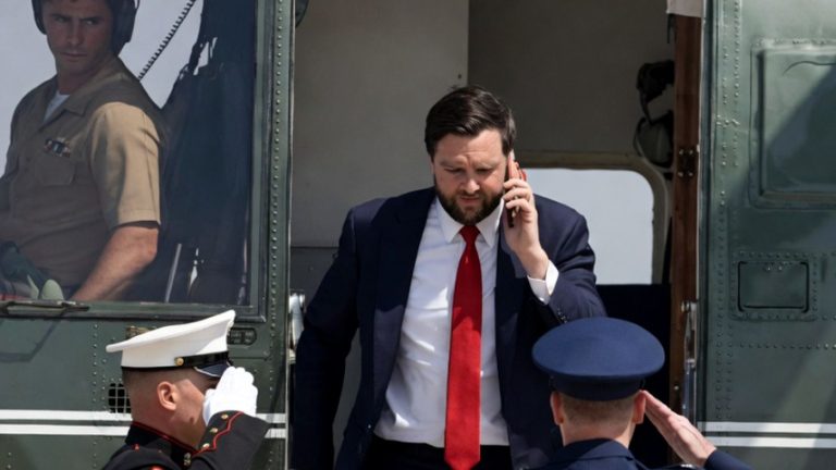 JD Vance exiting a military helicopter on the phone.