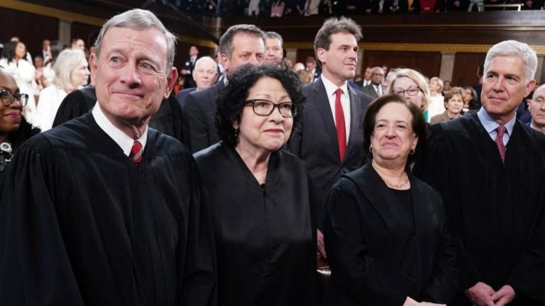 Supreme Court Justices standing at Capitol event.