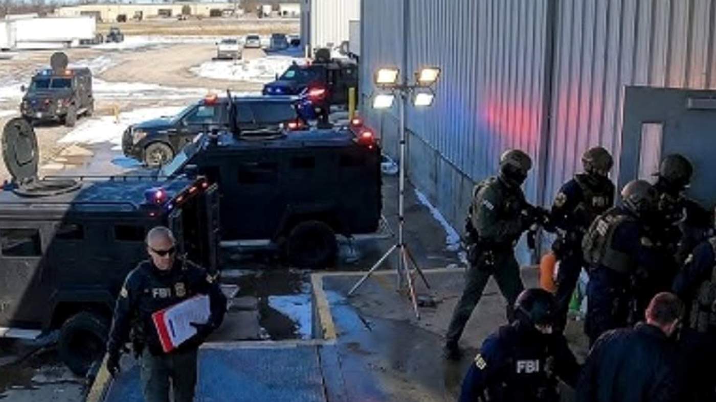 Federal law enforcement tactical raid immigration operation.