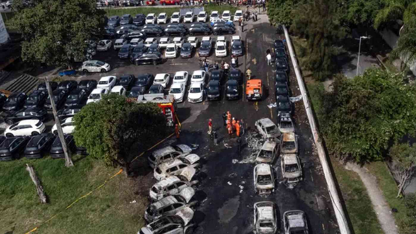 Aerial view of multiple burned cars in parking lot