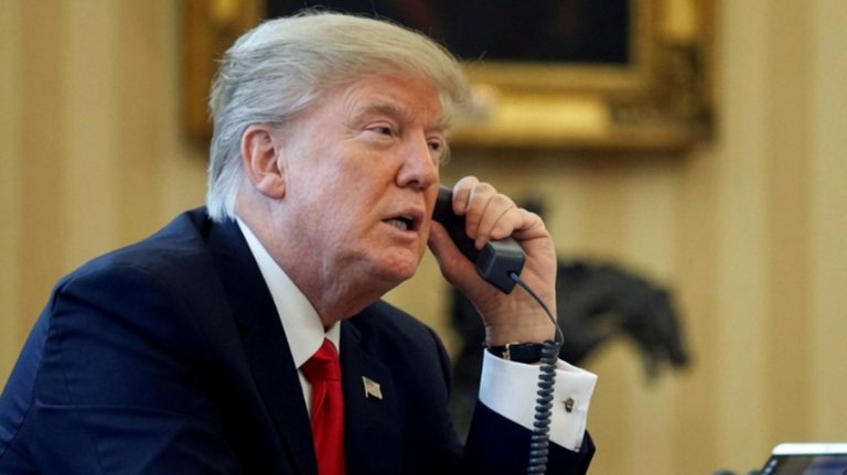 Donald Trump on the phone above Iran update text.