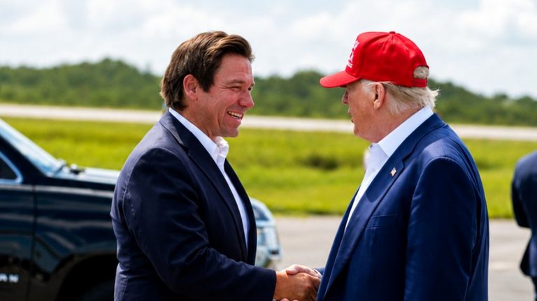 Donald Trump and Ron DeSantis shaking hands.